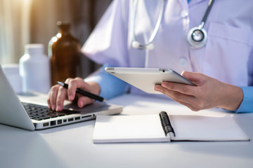 Medicine doctor hand working with modern digital tablet computer interface as medical network concept .