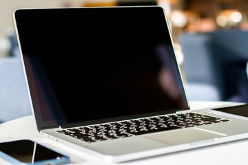 Aufkleber - Close up of modern laptop with blank screen in sunny interior, mockup. Business and technology concept