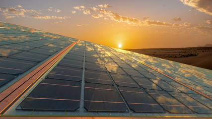 Wall Mural - clean energy concept, photovoltaic panels in the light of the rising sun