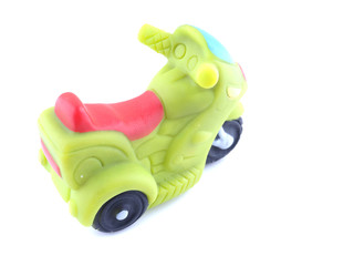 green rubber motorcycle toy on a white background