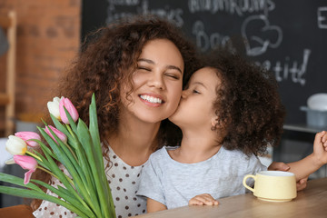 Sticker - African-American woman with flowers received from her little daughter at home