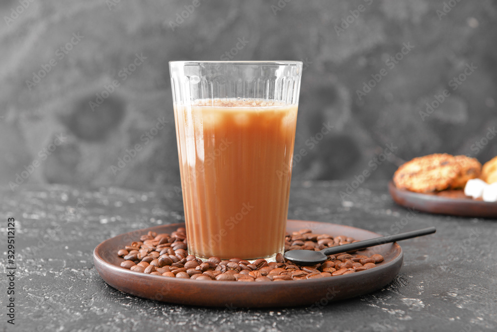 Glass of tasty iced coffee on dark background
