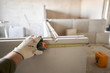 The construction worker measures with a tape measure Gypsum plate. Construction of internal walls in the apartment using a plaster concrete plate with groove ridge. tongue-and-groove gypsum blocks