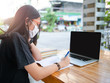 © anuchit2012 - social distancing student concept, Junior high school girl Do homework at home with laptop. the school is closed during an outbreak of the Coronavirus Covid-19 and Dust PM2.5 in Bangkok Thailand