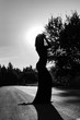 © Yekatseryna - Stylish girl in long dress posing in sunset