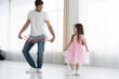 I love you, dad! Handsome young man is dancing at home with his little girl. Happy Father's Day!