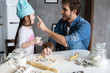 © opolja - Happy father and daughter having fun while cooking together.