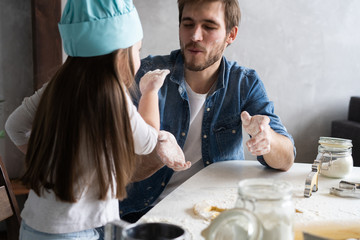 Wall Mural - Happy father and daughter having fun while cooking together.