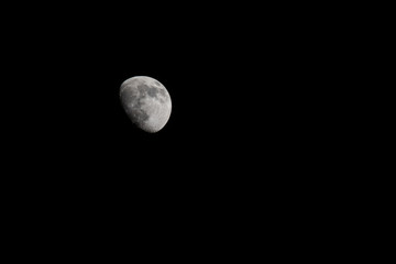Wall Mural - Closeup of a Three Quarter Moon in a Black Sky