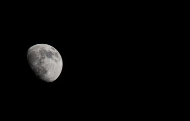Wall Mural - Closeup of a Three Quarter Moon in a Black Sky