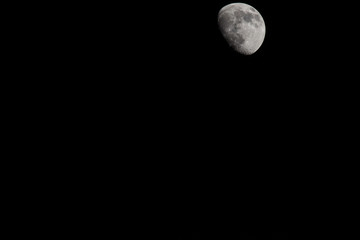 Wall Mural - Closeup of a Three Quarter Moon in a Black Sky