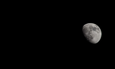 Wall Mural - Closeup of a Three Quarter Moon in a Black Sky