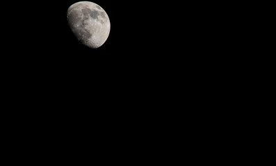 Wall Mural - Closeup of a Three Quarter Moon in a Black Sky