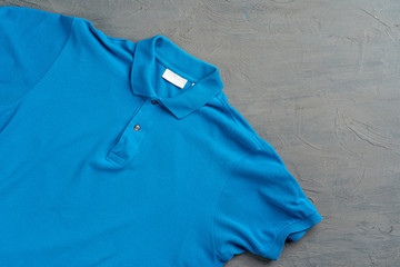 Wall Mural - Blue cotton polo t-shirt texture close up. Men's fashion