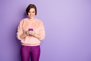 Sticker - Photo of pretty blogger lady toothy smiling holding telephone hands read interesting creative idea wear casual stylish pink pullover pants isolated purple color background