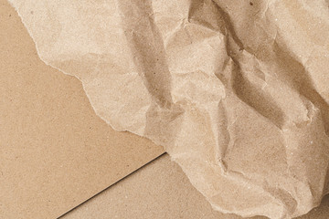 Crumpled craft paper with carton sheets close up, copy space