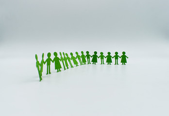 paper children figurine hold hands isolated on white. friendship concept