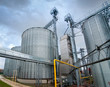 Silver silos at the plant for the production of agro-industrial equipment for processing dry cleaning and storage of agricultural products, flour, grain and grain stock photo