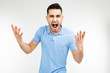 © Ivan Traimak - handsome guy in a blue t-shirt screaming at the camera on a white isolated background