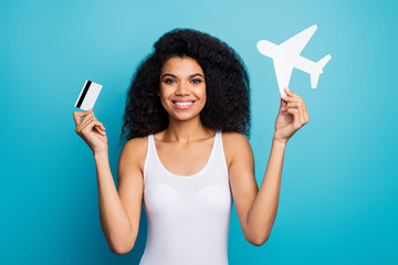 Poster - Close-up portrait of her she nice attractive cheerful wavy-haired girl holding in hands plane paper form credit card loan new life rout isolated on bright vivid shine vibrant blue color background