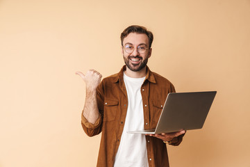 Poster - Man isolated using laptop computer pointing.