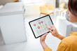 © rh2010 - Woman controlling smart home devices using a digital tablet with launched application. Smart home concept