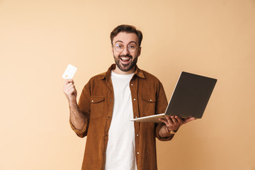 Sticker - Positive young unshaved man using laptop computer