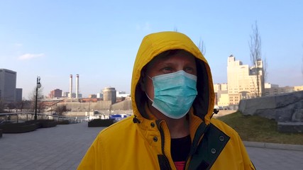 Wall Mural - Adult man in medical mask Looking around warily