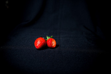 large strawberries on a black background