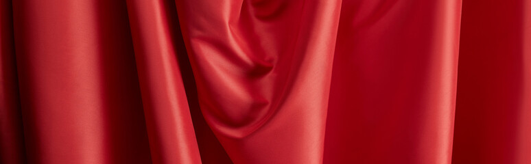 Wall Mural - close up view of red soft and wavy silk textured cloth, panoramic shot