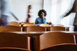 © BalanceFormCreative - In the university classroom, a beautiful black female student joins her peers, books and notes in hand, earnestly preparing for an upcoming lecture.