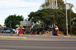 Arusha, Tanzania; 06/08/2019: African women waiting on the sidewalk of a sandy road in Arusha, Tanzania