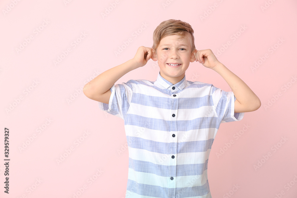Happy little boy with healthy teeth on color background