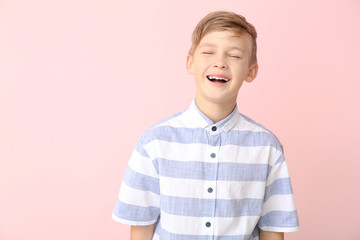 Wall Mural - Happy little boy with healthy teeth on color background