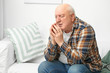 © Pixel-Shot - Portrait of elderly man praying at home