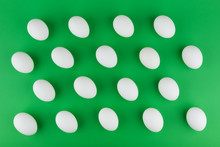 Pattern Of White Eggs On Green Background Top View