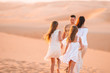 © travnikovstudio - People among dunes in desert in United Arab Emirates