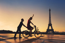 Happy Couple Having Fun In Paris Riding Bicycle Near Eiffel Tower, Silhouettes