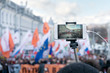 Blogger is reporting using a smartphone from a city street during a mass political action in Moscow, Russia.