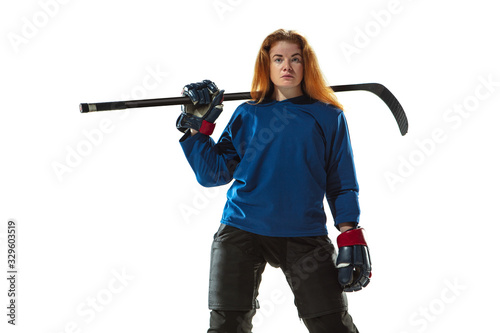 Young female hockey player with the stick on ice court and white background Tableau sur Toile