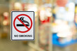 © chaophrayaart - No Smoking label in the public with blur nature background.