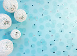 Fototapeta Dmuchawce - Composition of white balls from threads, sequins and tulle confetti on pastel blue background. Advertising content for the holiday. Flat lay, top view, copy space for your text