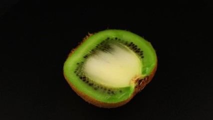 Poster - Kiwi spins on black background