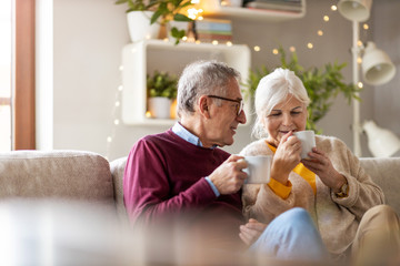 Poster - Portrait of a happy senior couple relaxing together at home 