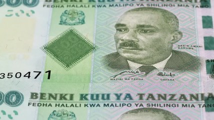 Wall Mural - Tanzania 500 shilling notes fast tracking. Tanzanian money. Slider shot, low angle. 4K