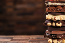 Tower Of White And Dark Chocolate With Nuts. Sweet Food As Dessert