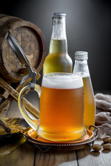 Light beer in a glass, on an old background.