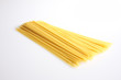 A studio photograph of loose uncooked spaghetti