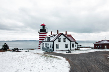 Snow Covered Red Striped Lighthouse on the Coast of Maine