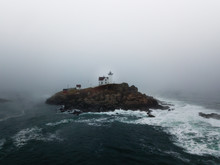 Fog Covered Lighthouse On The Coast Of Maine - Aerial
